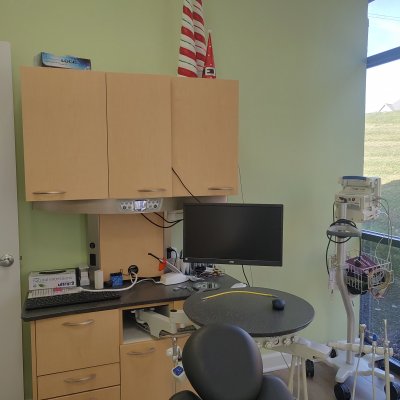 operatory with chair, computer monitor and shelving